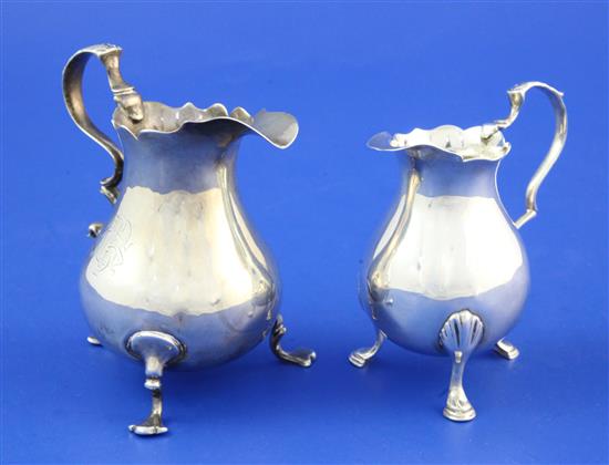 Two silver cream jugs.